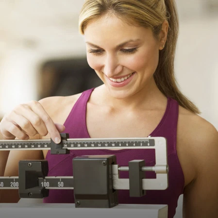 Weight Loss Louisville KY Woman Smiling at Scale